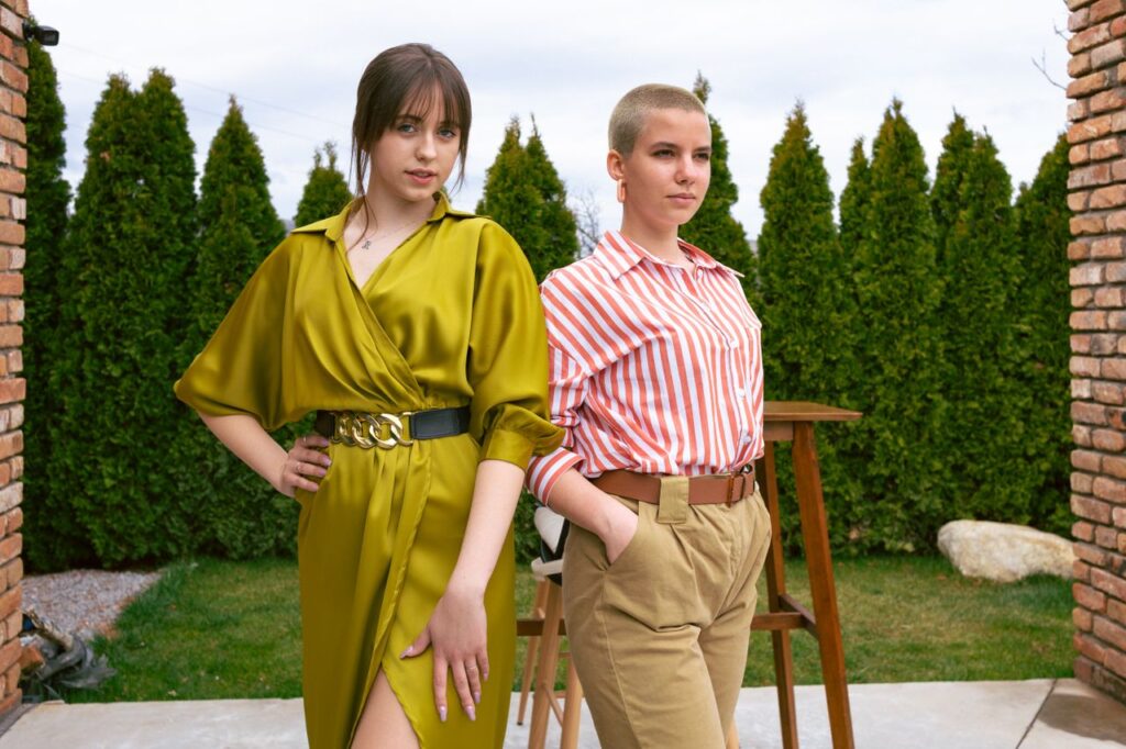 Crafting Captivating Headlines: Your awesome post title goes here Two women standing confidently in chic outfits, showcasing modern fashion trends.